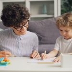 a woman and a child sitting at a table